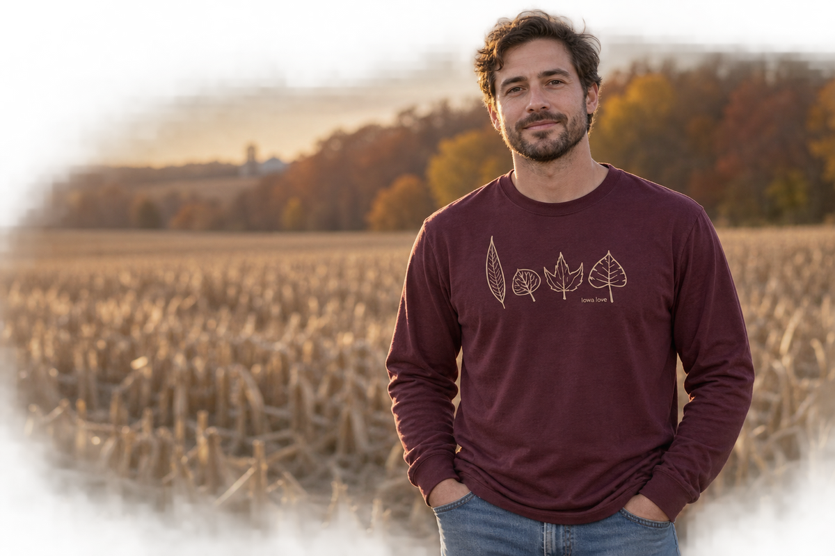 Man wearing the IOWA Leafs long sleeve in a harvested Iowa cornfield at sunset